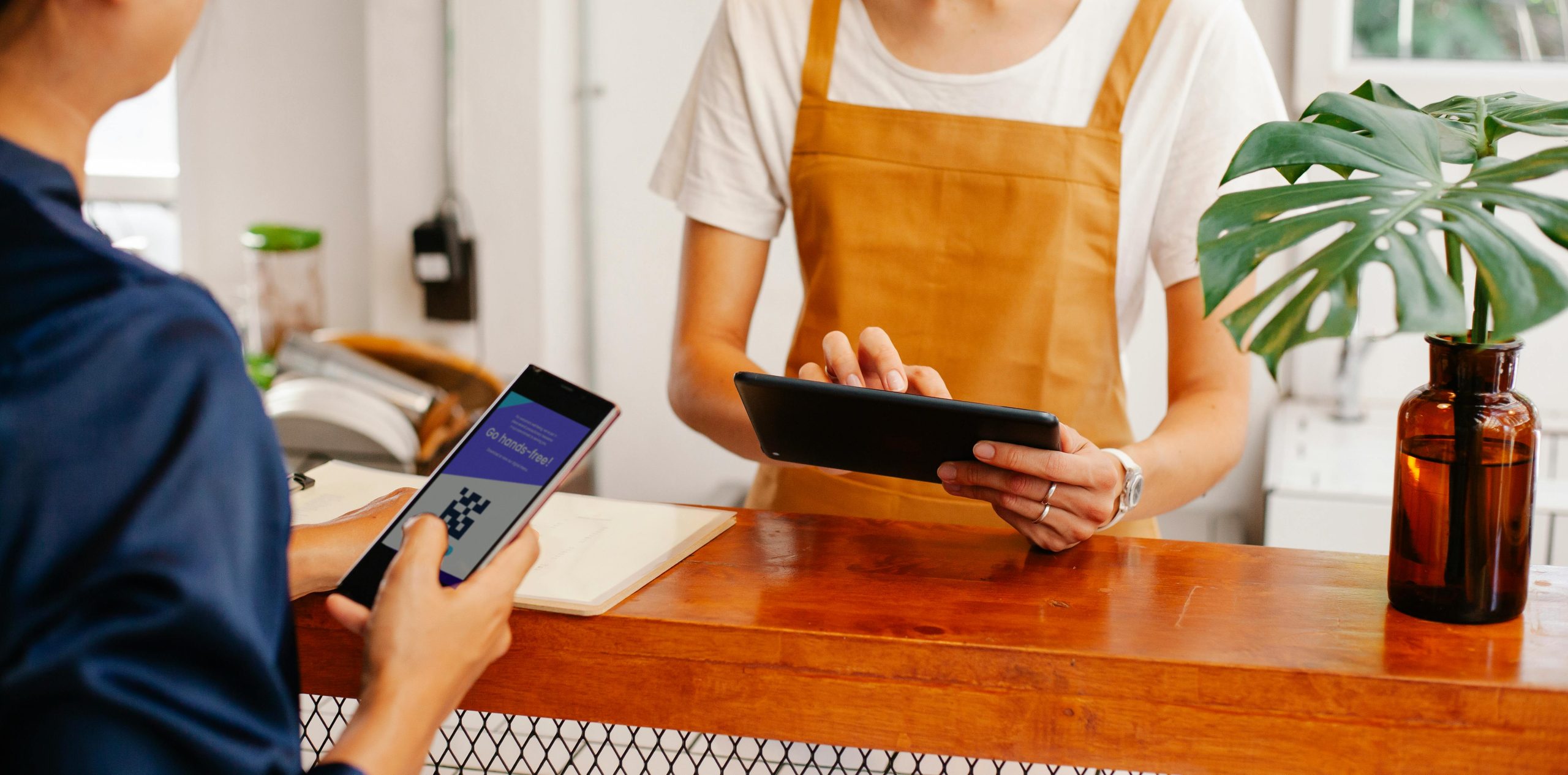 The image shows a person scanning a qr code on their phone